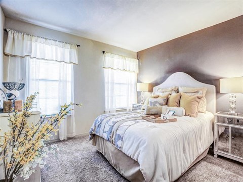 a bedroom with a bed and two windows