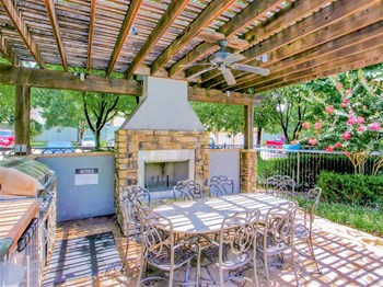 Outdoor fireplace and BBQ Grills at The Remington at Memorial in Tulsa, OK, For Rent. Now leasing 1 and 2 bedroom apartments. - Photo Gallery 4