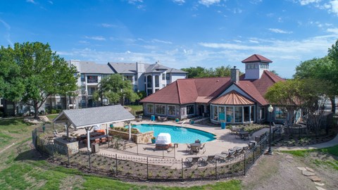 A house with a pool and a gazebo.