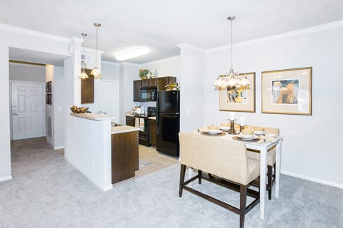 a dining room and kitchen with a table and chairs