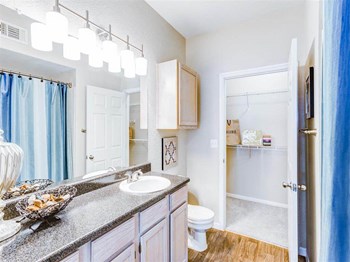 Walk in closet through bathroom at The Villas at Katy Trail in Uptown Dallas, TX, For Rent. Now leasing Studio, 1, 2 and 3 bedroom apartments. - Photo Gallery 6