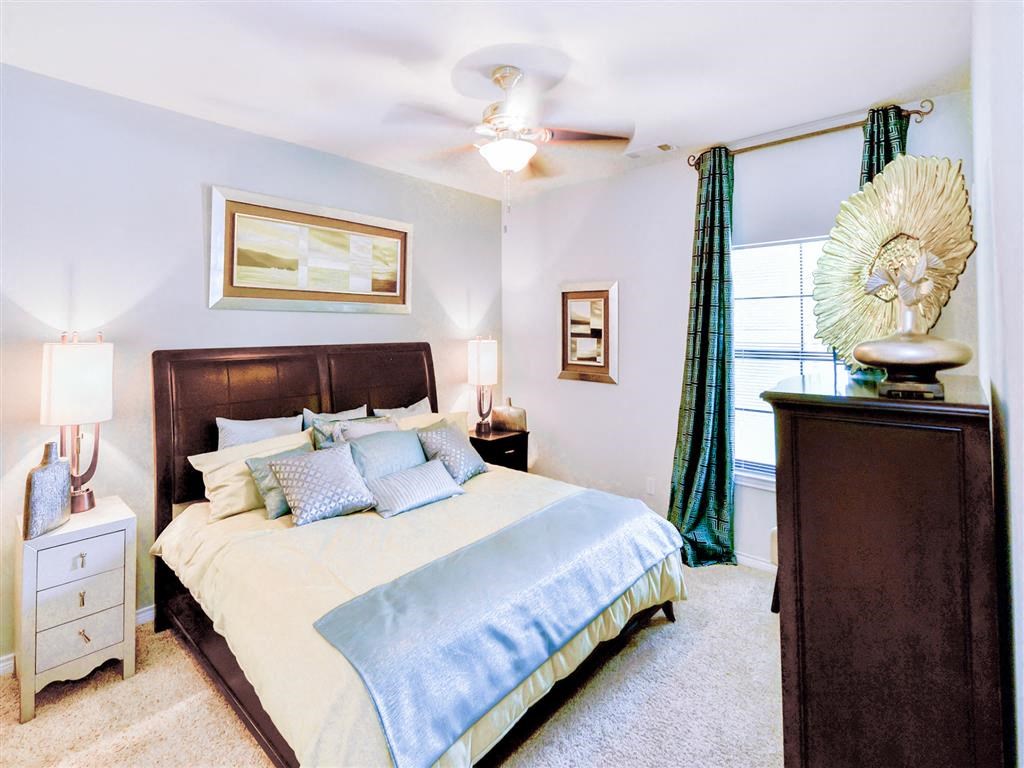 Bedroom with cozy bed at Mission at La Villita Apartments, Irving