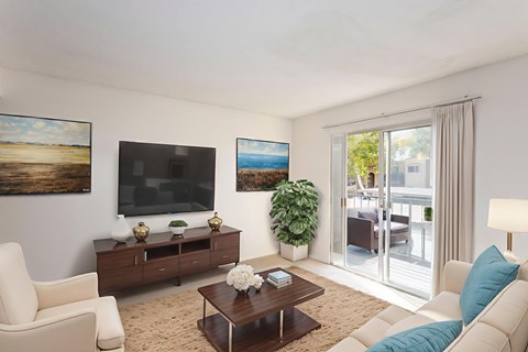 A living room with a white sofa, a wooden coffee table, and a painting on the wall.