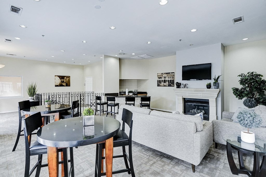 Interior living area with television and fireplace at Katy Trail Apartments, Dallas, TX