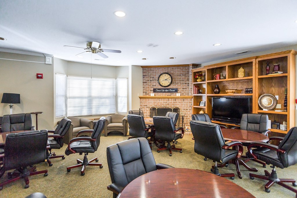 A conference room with a long table surrounded by chairs at Prairie Commons - 55+ Senior Community Apartments, Lawrence, KS
