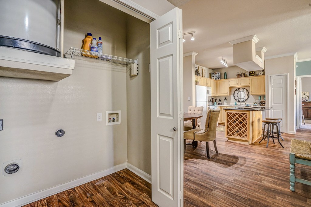 Laundry closets off of the kitchen in apartments at Cypress Lake at Stonebriar in Frisco, TX!