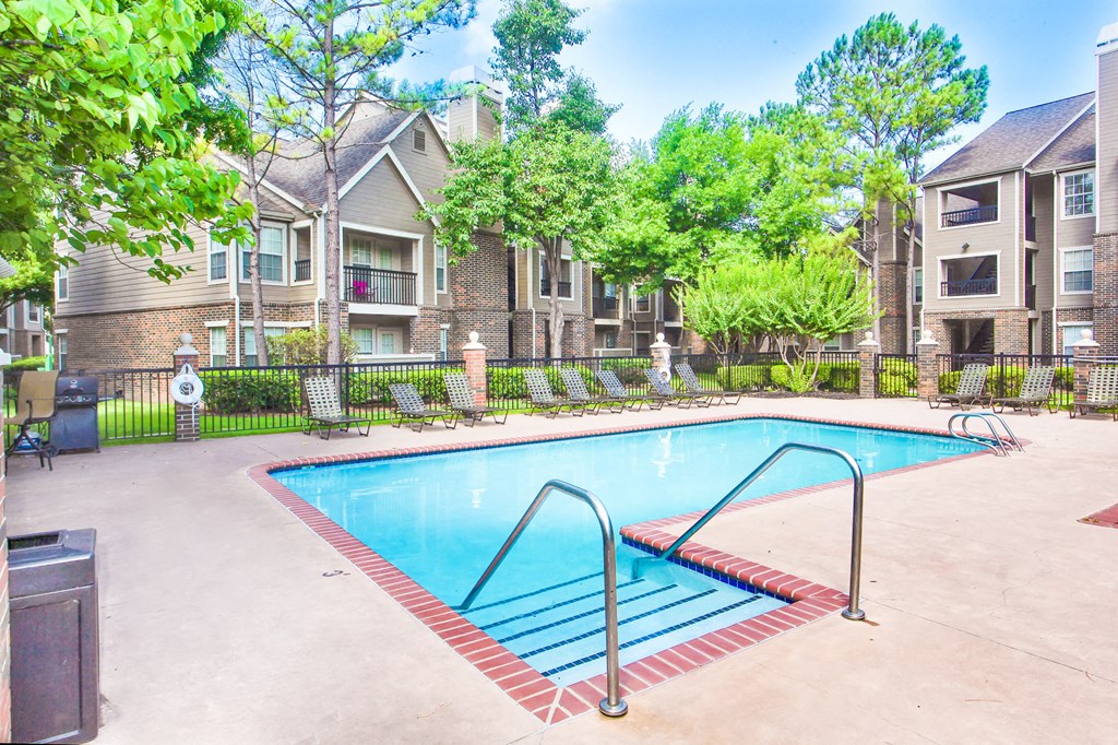 Swimming pool view with entry steps at Riverside Park Apartments, Tulsa, OK, 74136