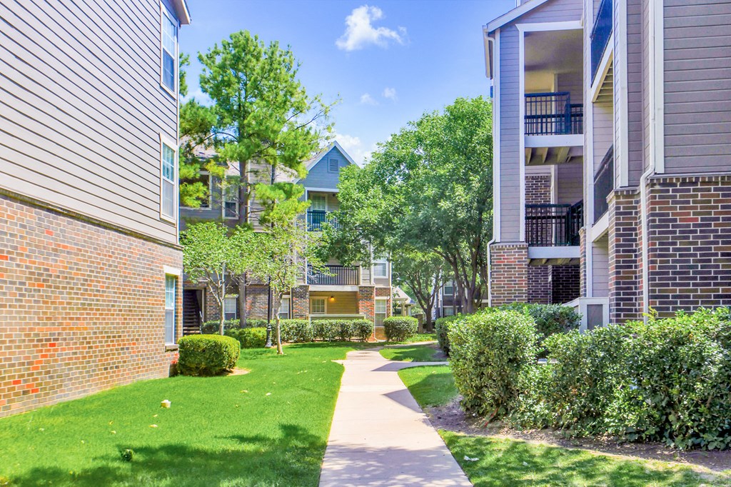 Walk way with green lawn and bushes at Riverside Park Apartments, Oklahoma, 74136