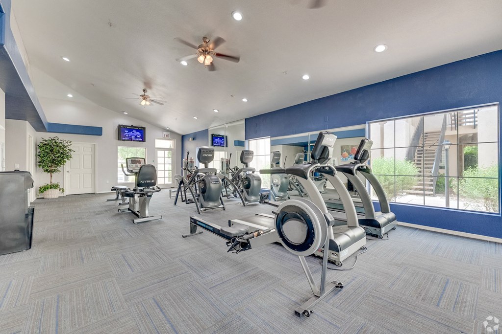 A gym with a variety of exercise equipment and a ceiling fan. at Ventana, Scottsdale, 85260