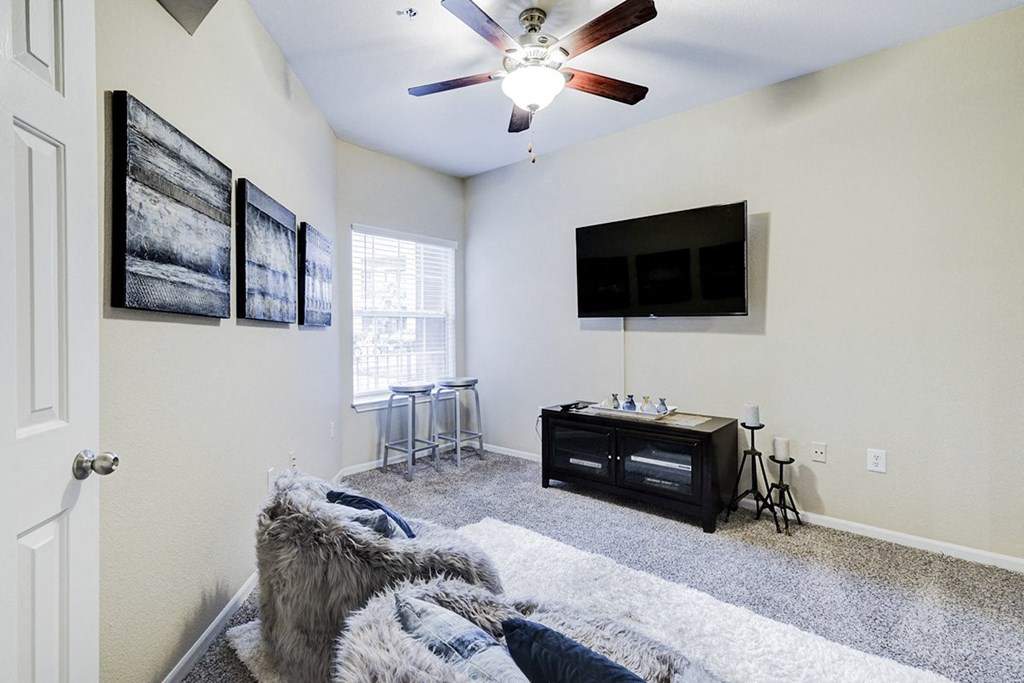 Interior living room with a ceiling fan and a tv at Villas at Katy Trail Apartments, Dallas, TX