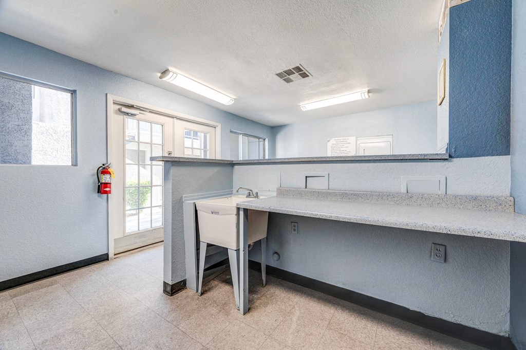 Folding station and basin sink in the laundry room at Country Club at The Meadows, Las Vegas, 89107