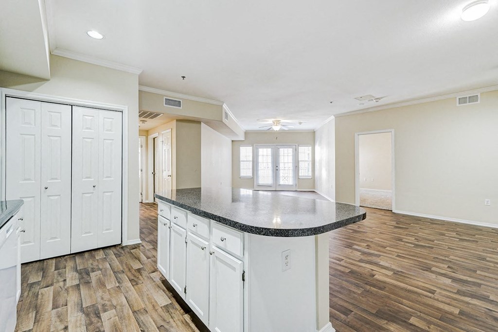 Spacious kitchen with granite counter tops and wood flooring at Villas at Katy Trail Apartments, Dallas, TX