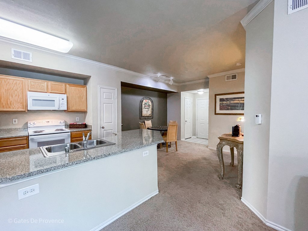 Kitchen counter view with dining room in the back  at Gates de Provence Apartments, Texas