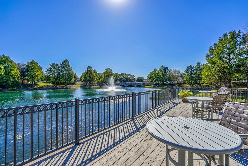 Deck with chairs overlooking the community lake at Cypress Lake at Stonebriar in Frisco, TX!