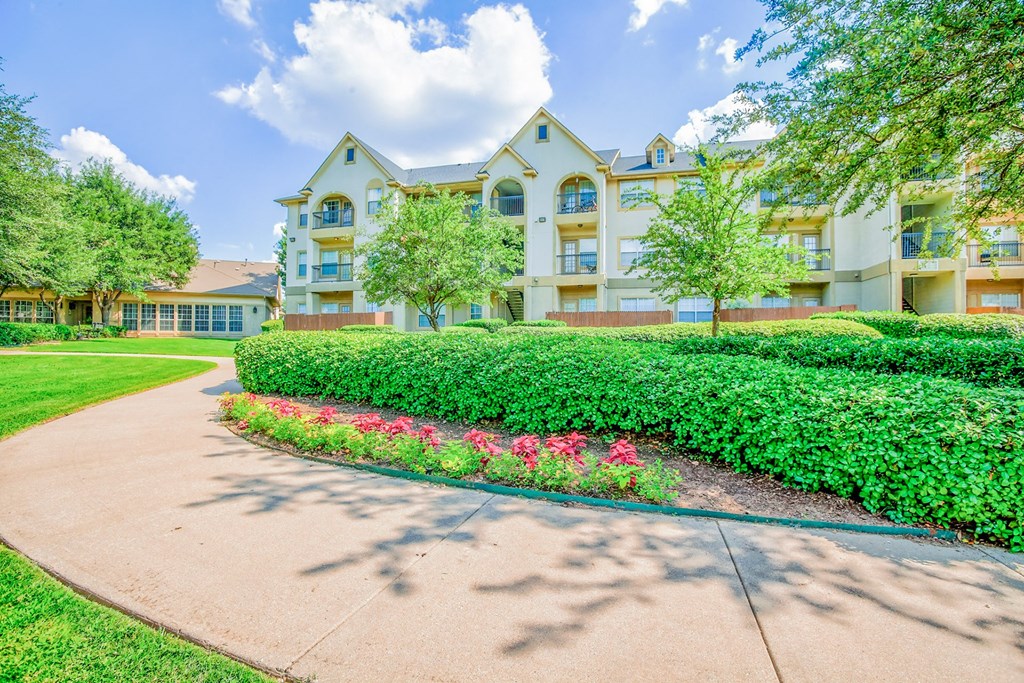 Lush landscaping with walkway at Tuscany Square, Dallas