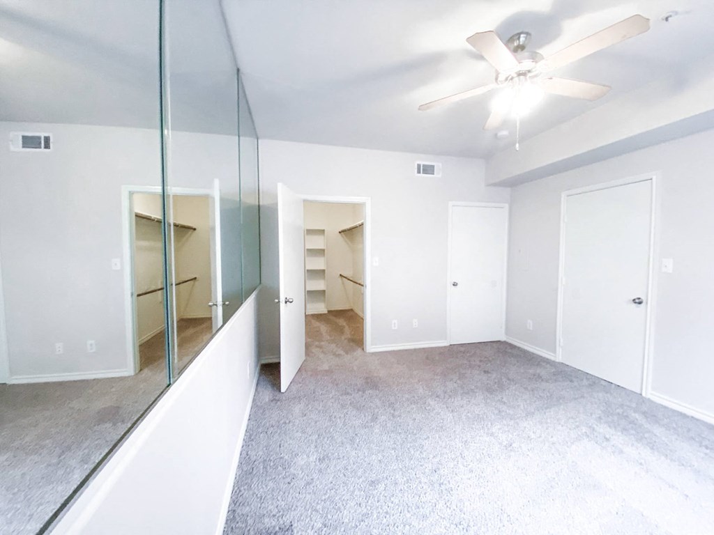 Spacious bedroom with huge mirror at Tuscany Square, Dallas, TX