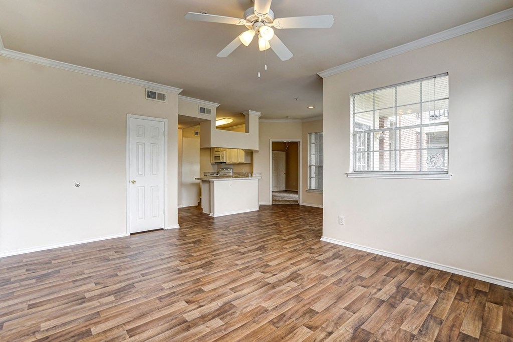 Wood-style Flooring with bright and spacious living rooms at Turnberry Isle Apartment Homes, Texas