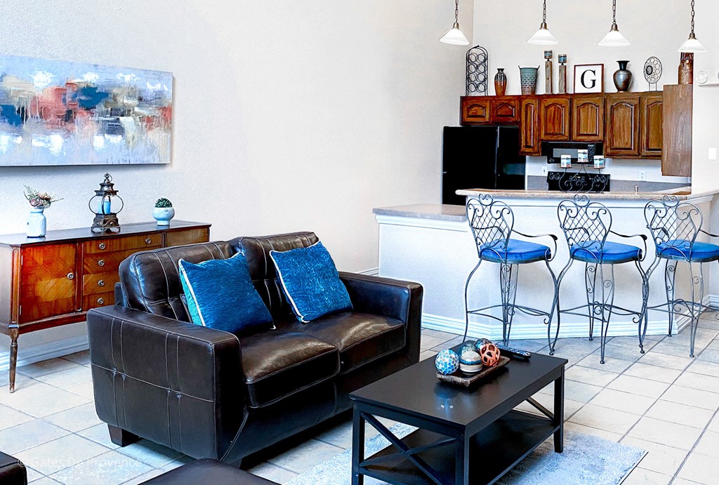 Gates de Provence clubhouse has a small kitchen and a seating area in front of a tv for residents to enjoy at Gates de Provence Apartments, Dallas