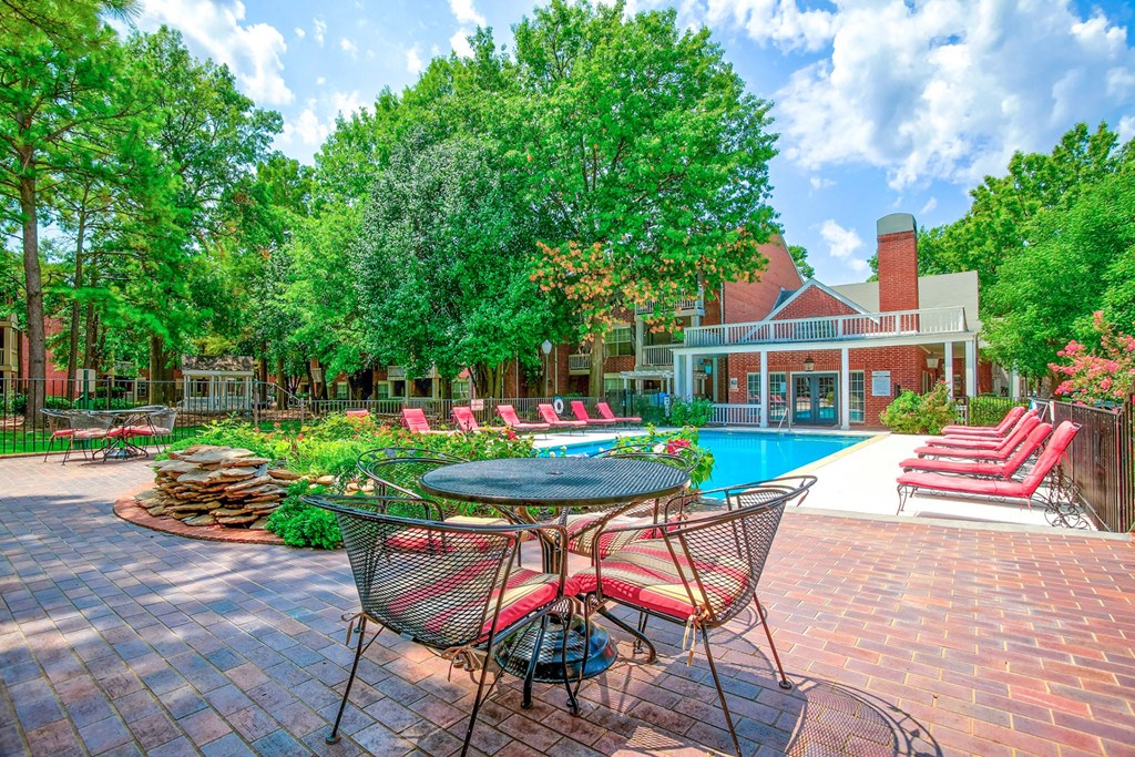 Outdoor pool with lounge chairs and tables at Greenbriar Apartments, Tulsa, OK, 74136