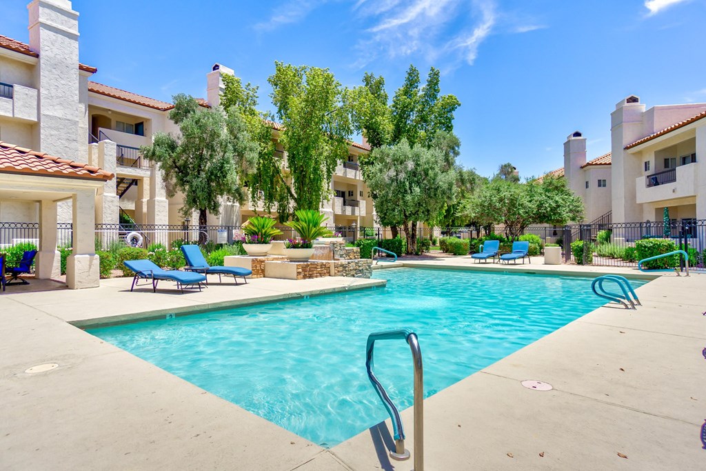 Outdoor swimming pool surrounded by blue lounge sat Ventana, Scottsdale, 85260