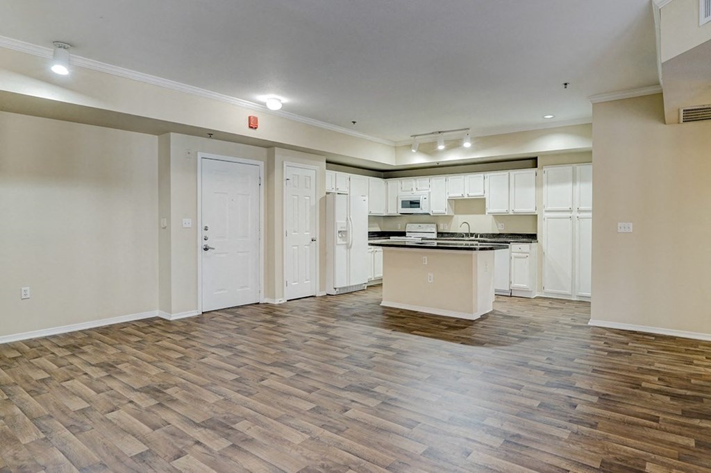 Open concept kitchen with hard wood flooring at Villas at Katy Trail Apartments, Dallas