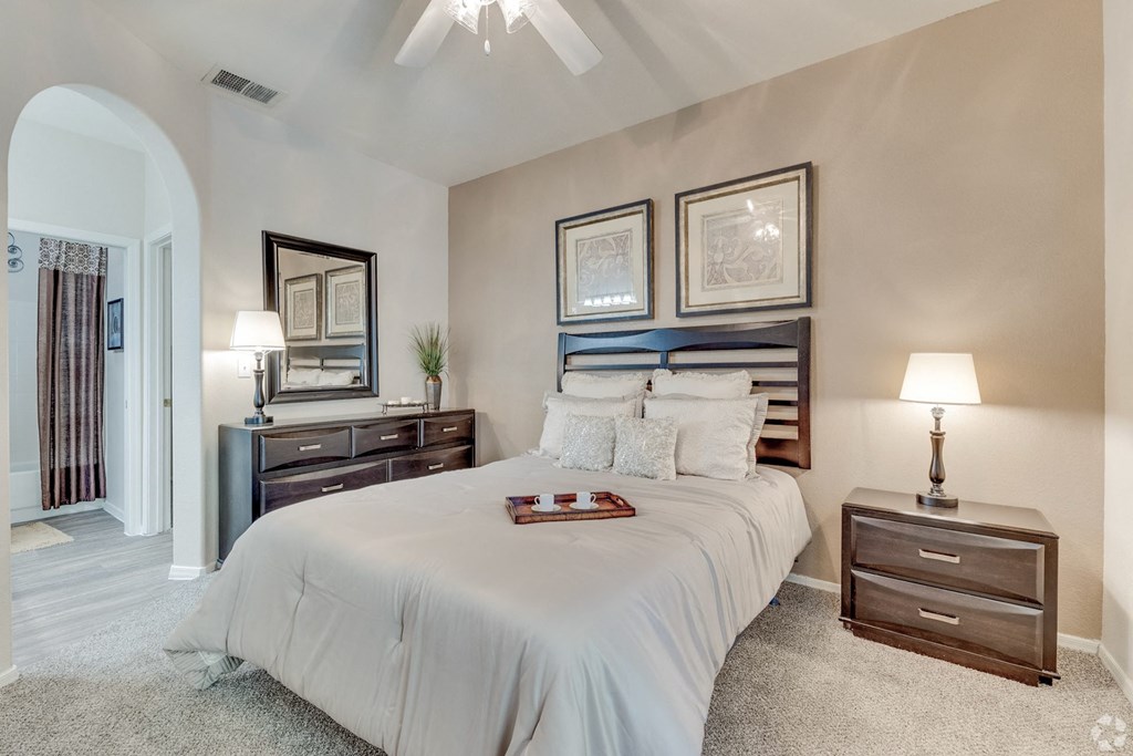 Large bedroom with archway and tan accent wall at Ventana, Scottsdale, Arizona