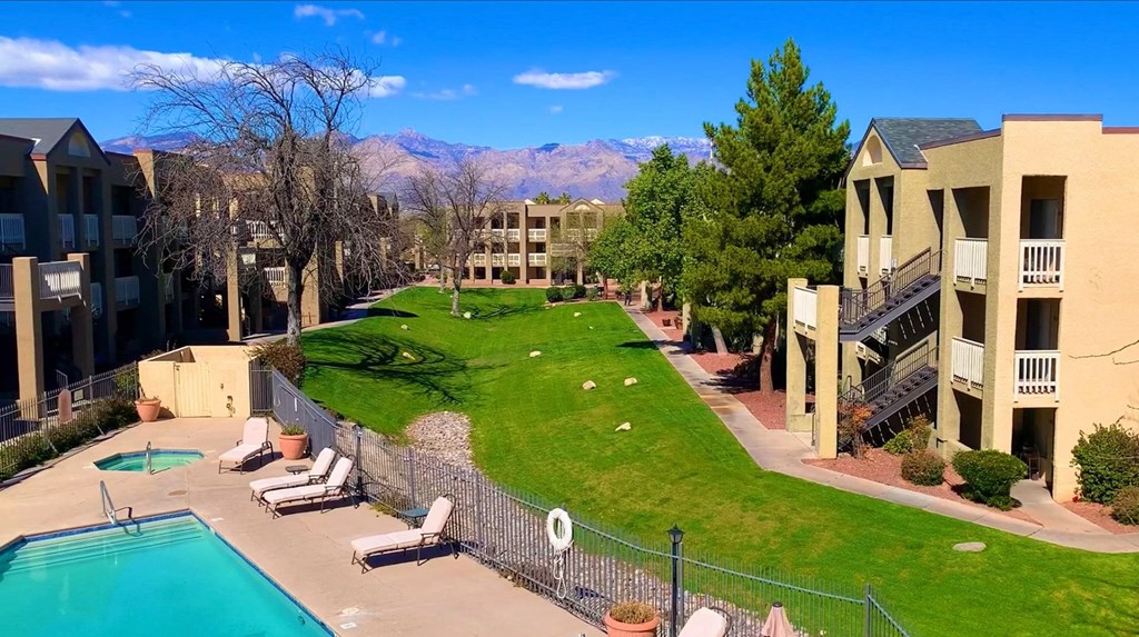an aerial view of a yard with a pool and apartment buildings at Pavilions at Pantano Apartments, Tucson, AZ, 85710