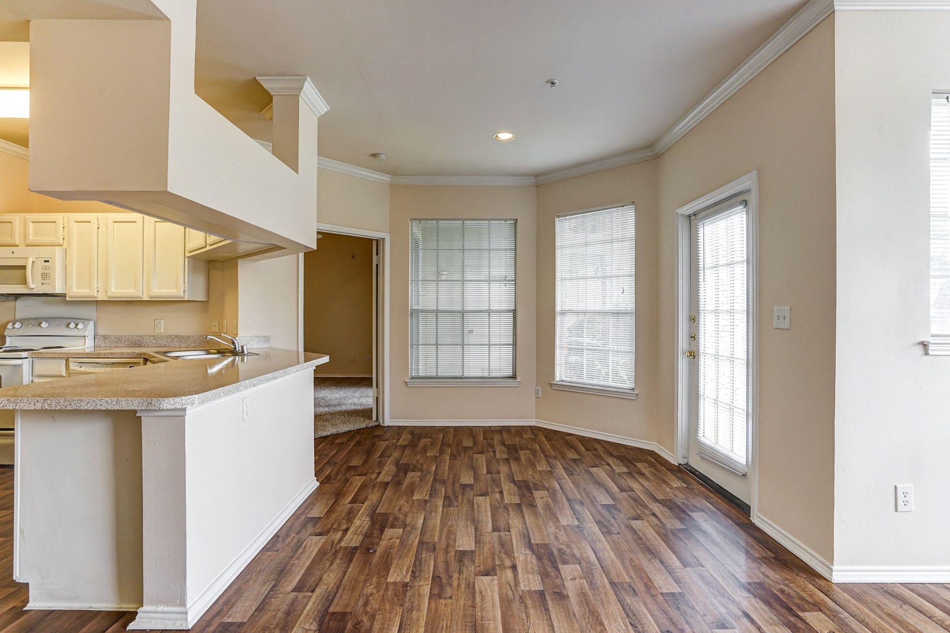 Spacious kitchens and dining rooms with wood floors at Turnberry Isle Apartments in Dallas, TX.