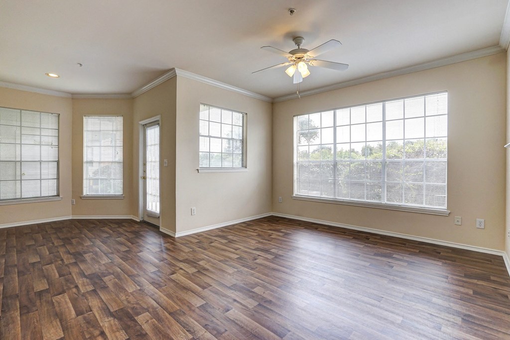 Bright living and dining rooms with large windows and wood flooring at Turnberry Isle Apartment Homes, Dallas, TX, Texas, 75248