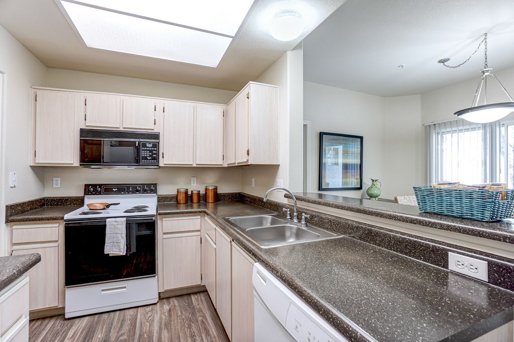 A kitchen with a stove, oven, microwave, and sink. at Ventana, Scottsdale, Arizona