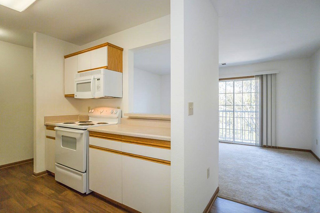 A kitchen with white appliances at Prairie Commons - 55+ Senior Community Apartments, Kansas, 66049