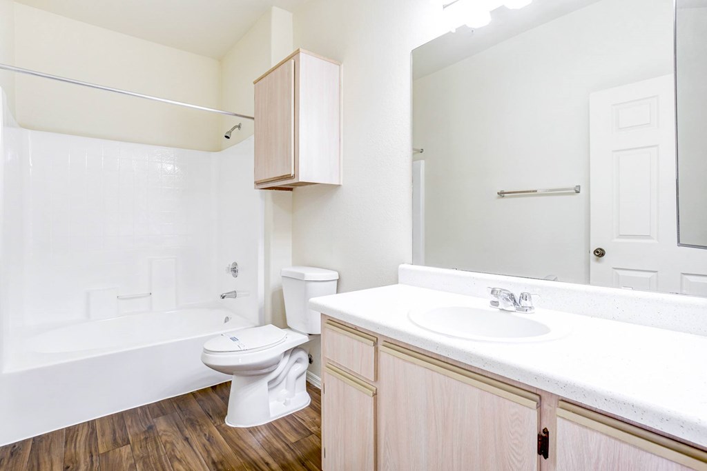 A white toilet sits in a bathroom next to a white sink. at Ventana, Scottsdale, AZ