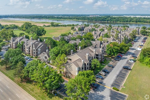 A bird's eye view of a residential area with houses and parked cars.