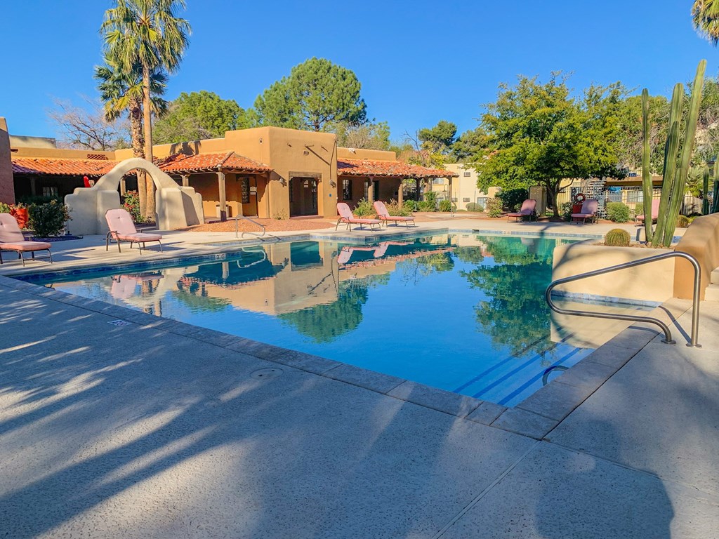 Resort-style swimming pool with lounge chairs at La Hacienda Apartment, Tucson, AZ, 85712