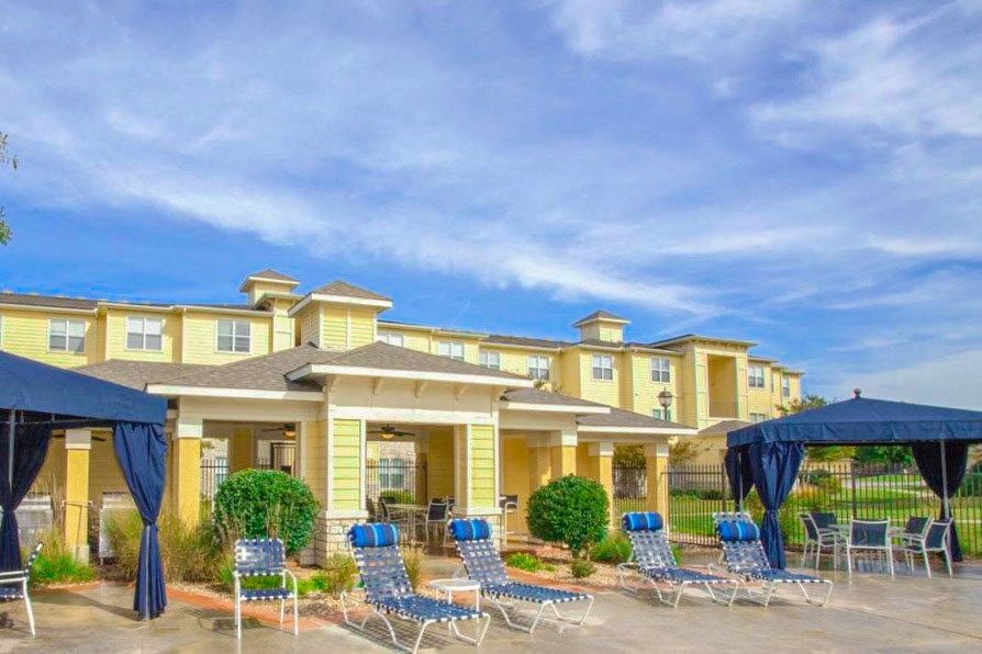 Exterior of apartment with lounge chairs at Sonoma Grande Apartments, Oklahoma, 74133