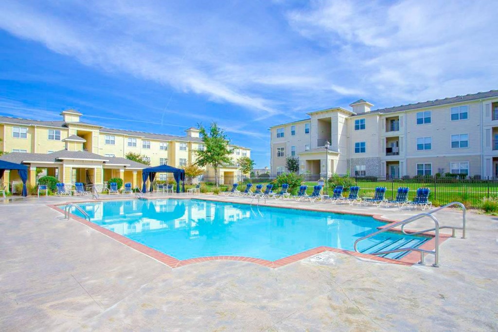Resort-style pool with stone pavement surrounding it at Sonoma Grande Apartments, Tulsa, OK