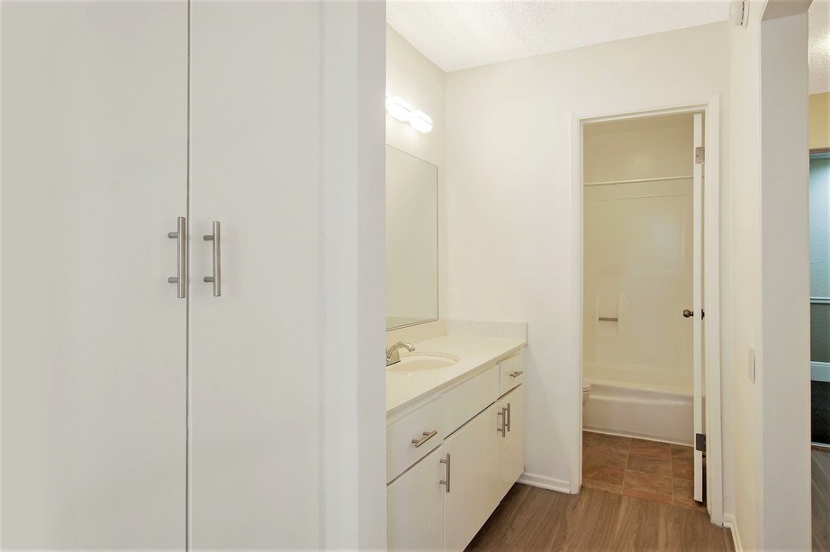 an empty bathroom with a sink and a mirror