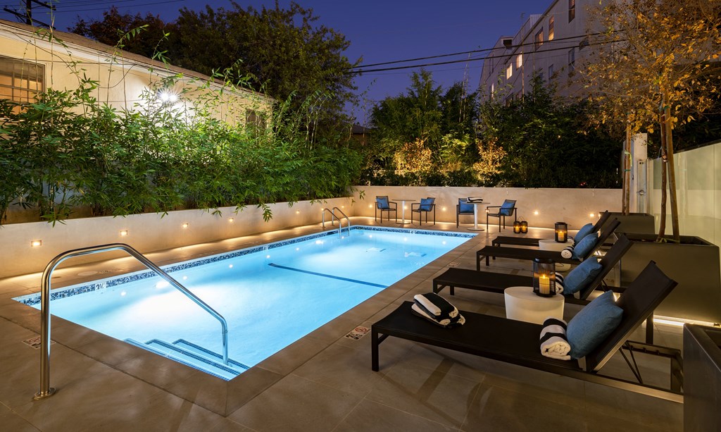 a swimming pool at night at the ace hotel