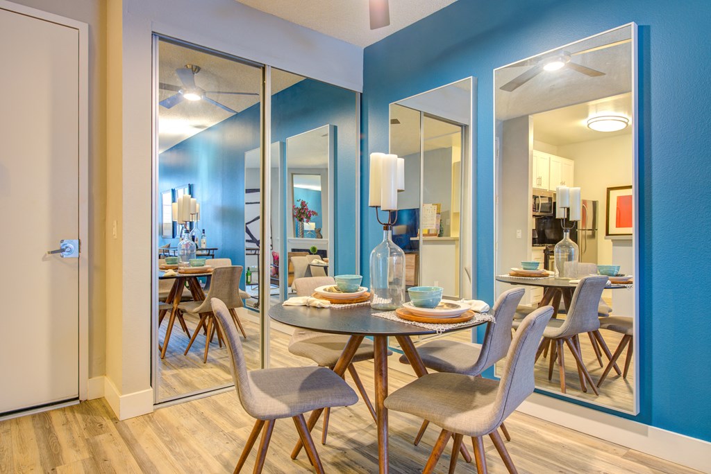a dining room with a table and chairs