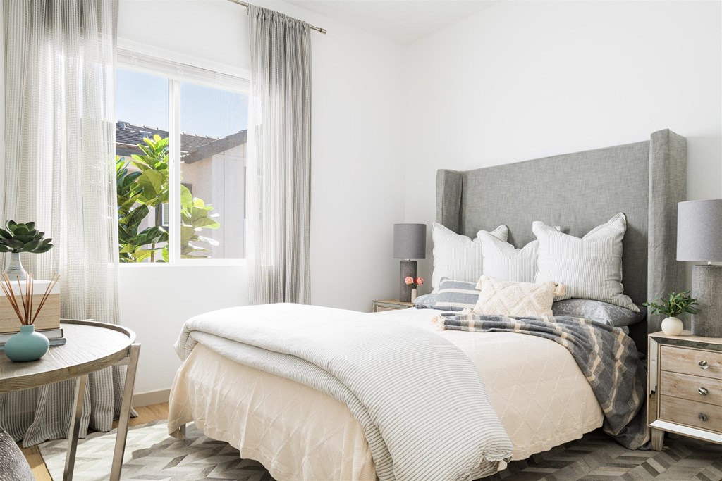 a bedroom with a bed and a window