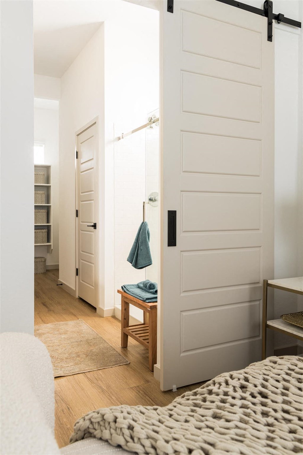 a bedroom with a bed and a closet with a white door