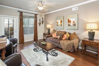 Photo of a model apartment showing the living room with couch and coffee table - Photo Gallery 2