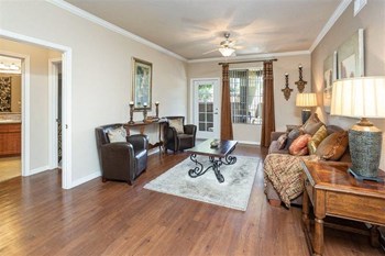 Superstition Canyon Model Living Room Photo of a model apartment showing the living room with couch, 2 leather chairs and coffee table. - Photo Gallery 3