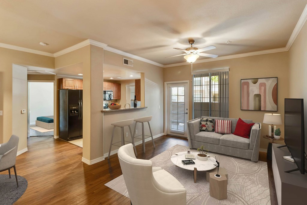 A living room with a grey couch, a coffee table, and a television.