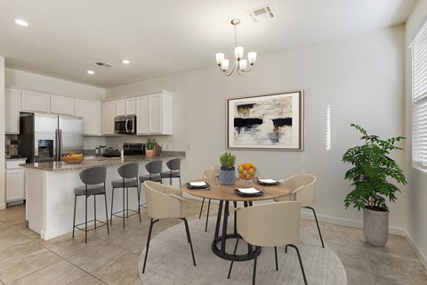 an open kitchen and dining room with a table and chairs