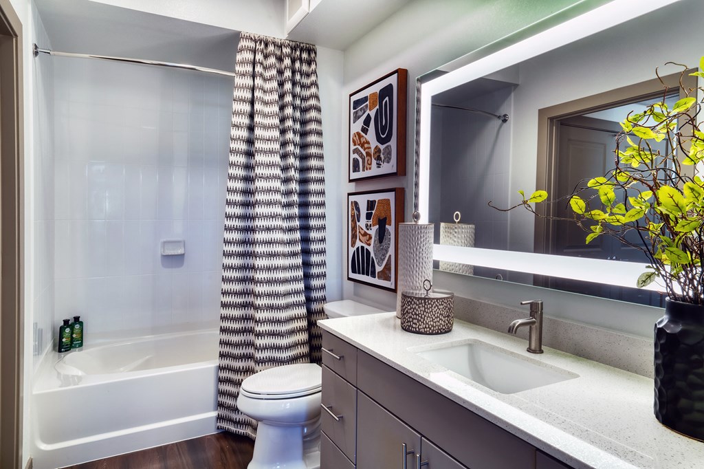 a bathroom with a shower and a sink and a toilet