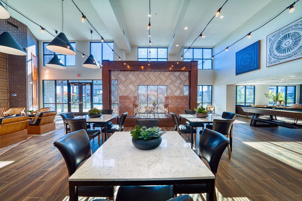 a large dining room with tables and chairs and a fireplace