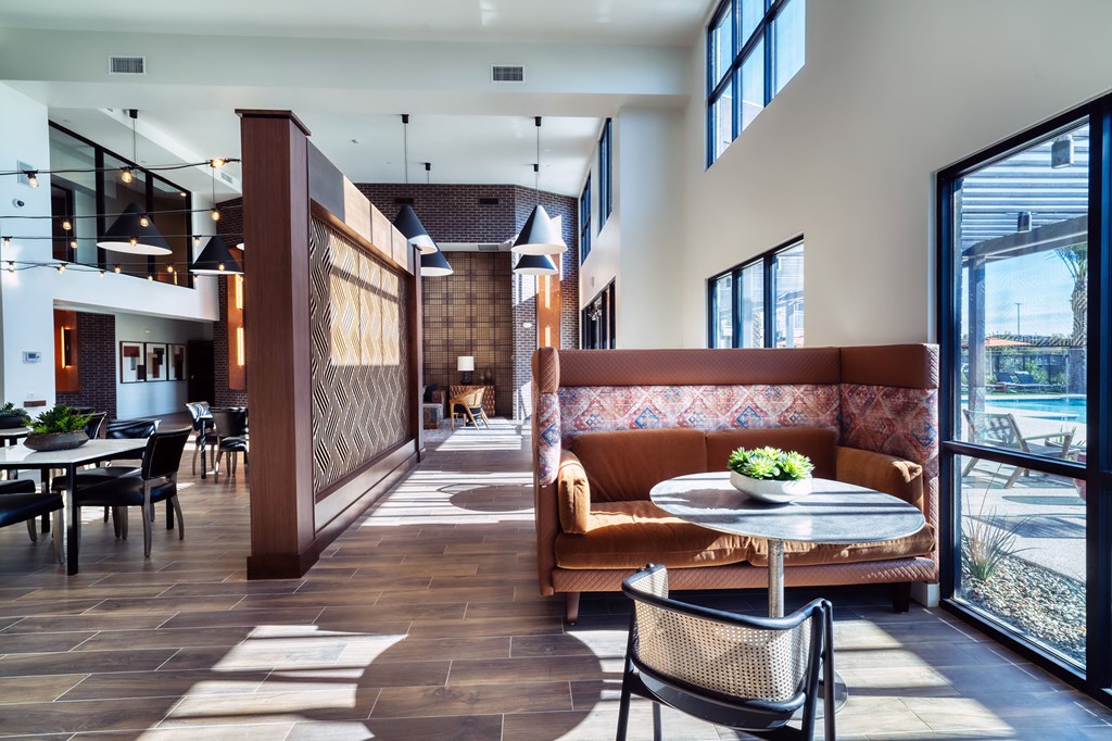 a lounge area with a couch and a table with chairs