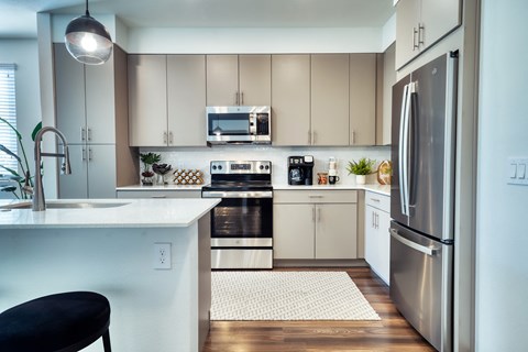 a kitchen with stainless steel appliances and white cabinets