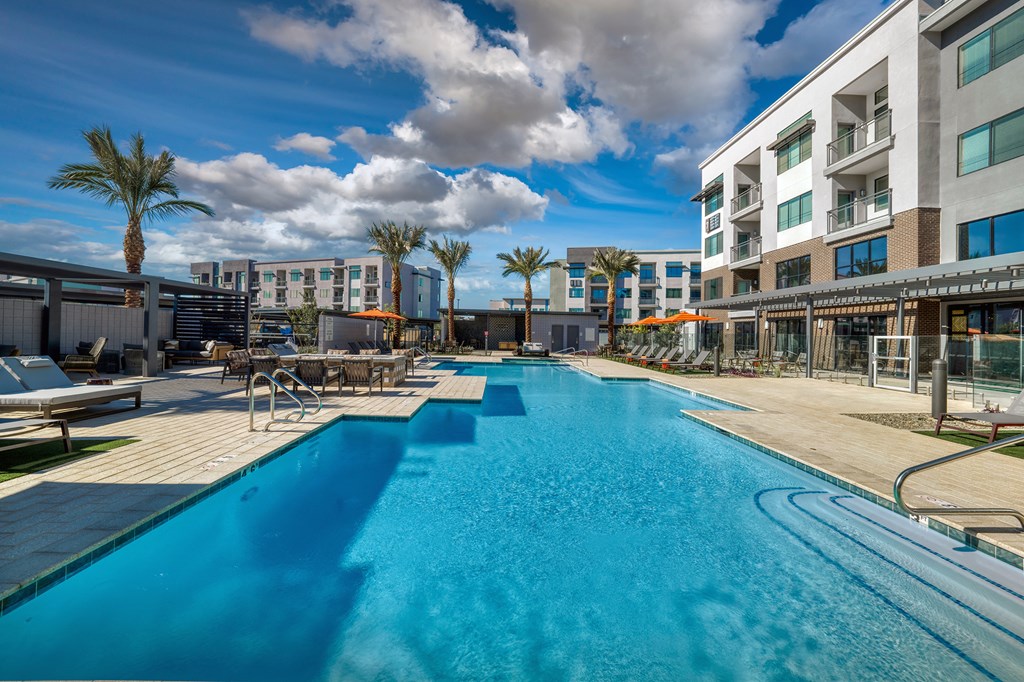 a swimming pool at a hotel with palm trees